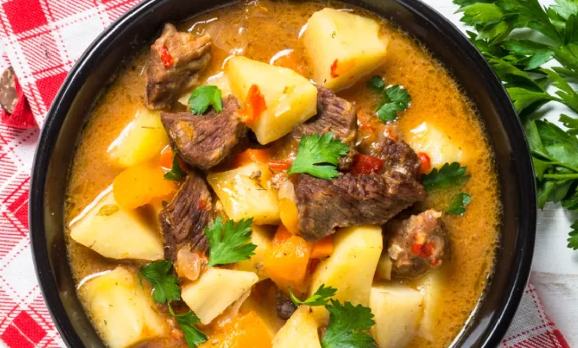 Bosanski lonac with chunks of meat, potatoes, and vegetables in broth